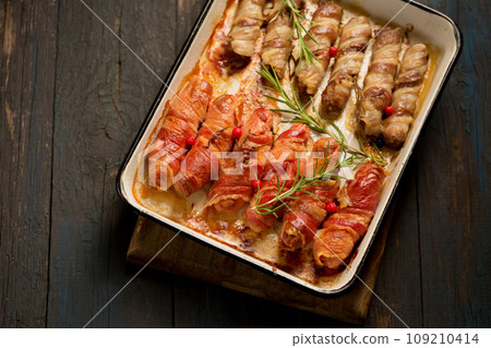 Traditional Christmas dish Sausages wrapped in bacon Traditional Christmas dish Sausages wrapped in bacon 109210414