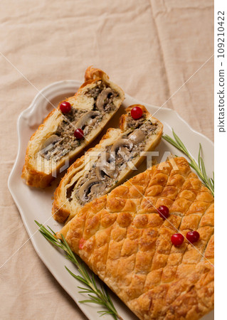 Christmas vegetarian pie Wellington stuffed with mushrooms 109210422