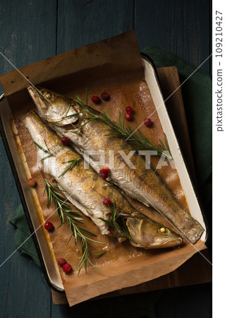 Baked pikes with rosemary and cranberries, a light Christmas meal 109210427