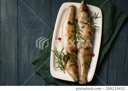 Baked pikes with rosemary and cranberries, a light Christmas meal Baked pikes with rosemary and cranberries, a light Christmas meal 109210432