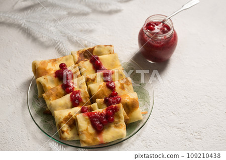 Pancakes stuffed with cheese with cranberry sauce, winter dessert 109210438