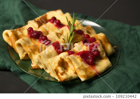 Pancakes stuffed with cheese with cranberry sauce Pancakes stuffed with cheese with cranberry sauce 109210442