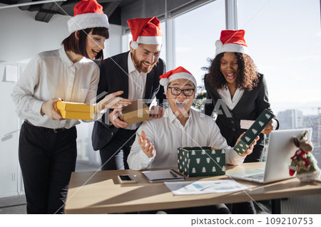 Group of business colleagues Christmas gift boxes to Asian male manager 109210753