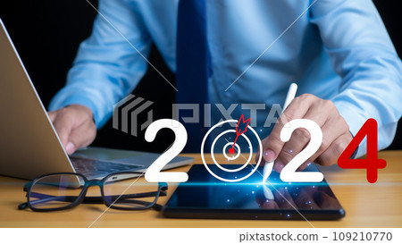Stock trading. Finance. Investment. Growing business. Businessman in suit pointing with pen at tablet screen and lettering 2024 showing concept of setting goals and business growth in 2024 Stock trading. Finance. Investment. Growing business. Businessman in suit pointing with pen at tablet screen and lettering 2024 showing concept of setting goals and business growth in 2024 109210770