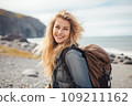 Beautiful young woman on a beach with backpack 109211162
