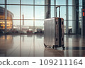 Silver suitcase in an airport hallway 109211164