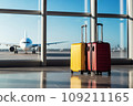 Two suitcases in an airport hallway 109211165