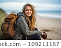 Beautiful young woman on a beach with backpack 109211167