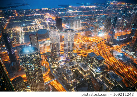 Top view skyline cityscape city in night illuminations. Street night traffic in Dubai. Waterfront and Dubai cityscape in summer evening illuminations. Cityscape background of Dubai. High quality photo Top view skyline cityscape city in night illuminations. Street night traffic in Dubai. Waterfront and Dubai cityscape in summer evening illuminations. Cityscape background of Dubai. High quality photo 109211248