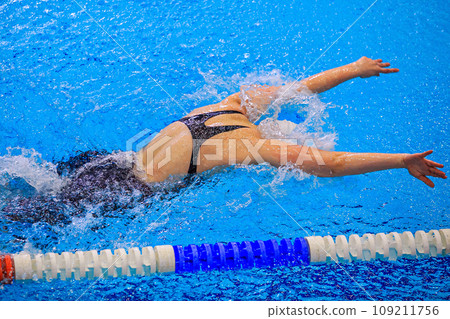 female swimmer swim butterfly stroke competition race, summer sports games 109211756