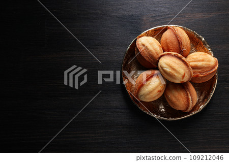 Cookies Nuts in a bowl on a dark background Cookies Nuts in a bowl on a dark background 109212046