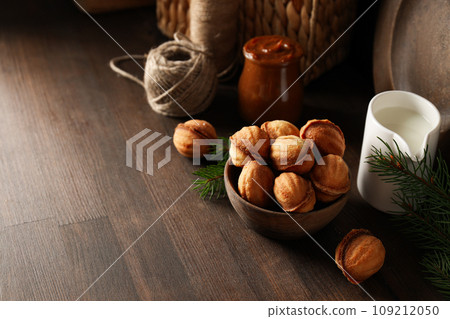 Cookies Nuts in a bowl with a sprig of needles 109212050