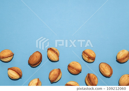 Cookies in the form of nuts on a blue background Cookies in the form of nuts on a blue background 109212060