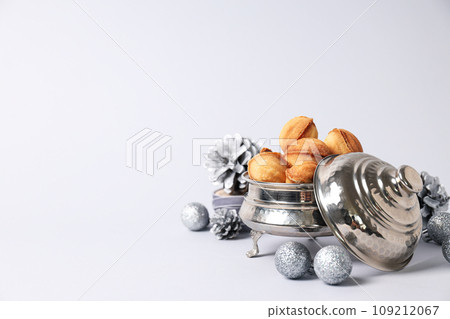 Cookies Nuts in a silver bowl with cones Cookies Nuts in a silver bowl with cones 109212067