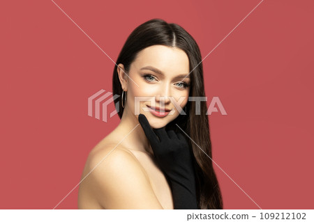 Attractive girl in black gloves on a red background 109212102