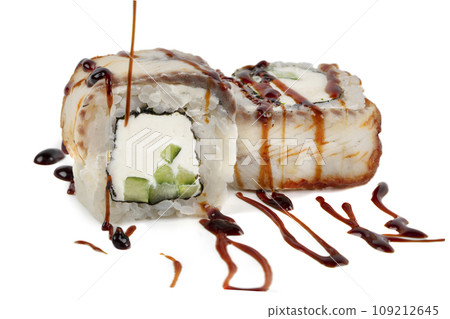 Sushi closeup isolated on white background. Sushi roll with graham rice, Philadelphia cheese and celery topped with soy sauce. Japanese restaurant menu. Sushi closeup isolated on white background. Sushi roll with graham rice, Philadelphia cheese and celery topped with soy sauce. Japanese restaurant menu. 109212645
