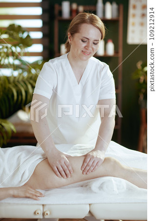 medical massage therapist in spa salon massaging clients leg medical massage therapist in spa salon massaging clients leg 109212914