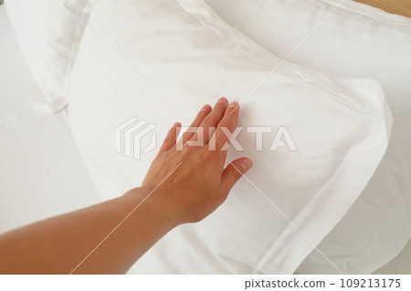 A soft, white pillow on the bed A soft, white pillow on the bed 109213175