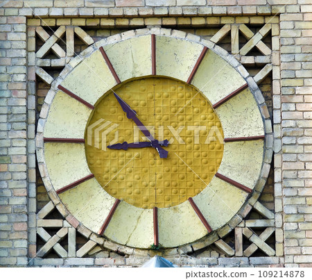 Kiev, Ukraine July 6, 2021: Antique clock on the building of the National Technical University of Ukraine - Kiev Polytechnic Institute named after Sikorsky in the city of Kiev Kiev, Ukraine July 6, 2021: Antique clock on the building of the National Technical University of Ukraine - Kiev Polytechnic Institute named after Sikorsky in the city of Kiev 109214878