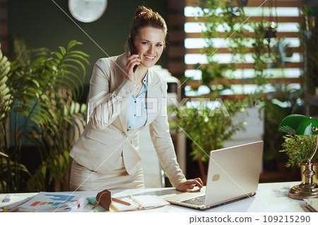 happy business woman in green office talking on phone 109215290