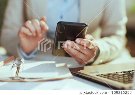 Modern bookkeeper woman in green office using phone 109215293