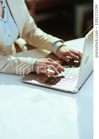 Modern bookkeeper woman in light business suit in green office 109215294