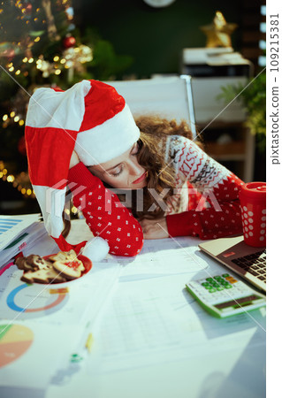tired stylish sleeping in green office with Christmas tree 109215381