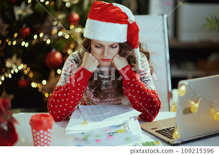 business woman in green office with Christmas tree working 109215396