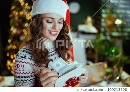 smiling business woman in green office with Christmas tree smiling business woman in green office with Christmas tree 109215398