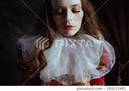 medieval queen in red dress with white collar 109215481