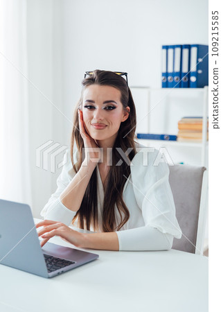 remote work communication online beautiful brunette with a cup at the laptop remote work communication online beautiful brunette with a cup at the laptop 109215585