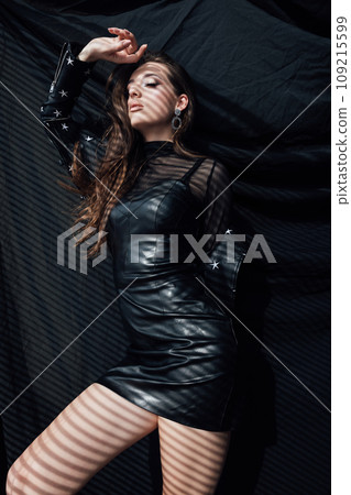 Beautiful brunette woman posing on black background Beautiful brunette woman posing on black background 109215599