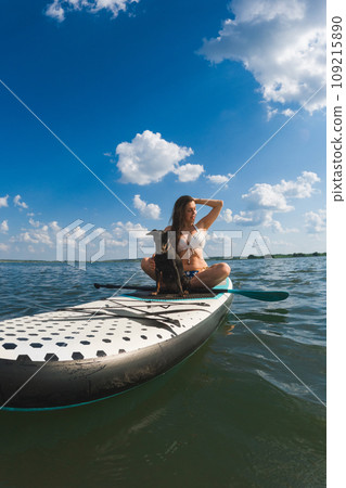 happy woman with dog on supboard 109215890