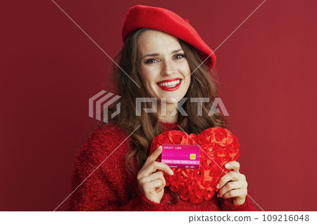 smiling trendy 40 years old woman in red sweater and beret smiling trendy 40 years old woman in red sweater and beret 109216048