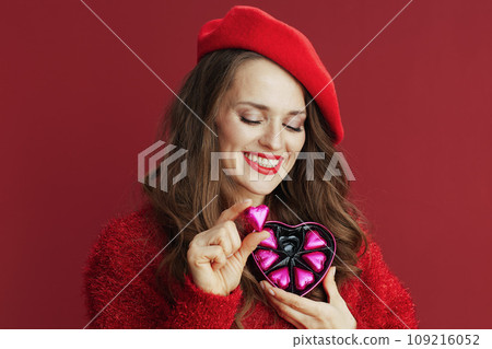 smiling elegant 40 years old woman in red sweater and beret smiling elegant 40 years old woman in red sweater and beret 109216052