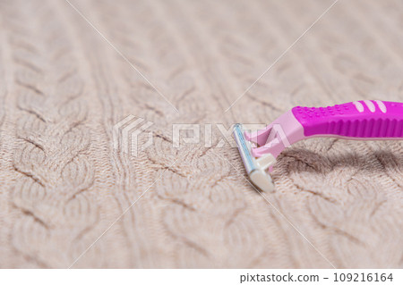 Razor on sweater. Removing pills from clothing Razor on sweater. Removing pills from clothing 109216164