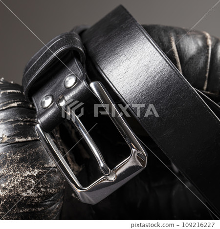 Part of a black crocodile leather belt. Expensive leather goods. 109216227