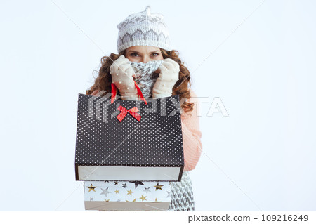 stylish woman in sweater, mittens, hat and scarf on white stylish woman in sweater, mittens, hat and scarf on white 109216249