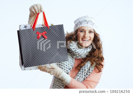 happy trendy woman in sweater, mittens, hat and scarf on white happy trendy woman in sweater, mittens, hat and scarf on white 109216250