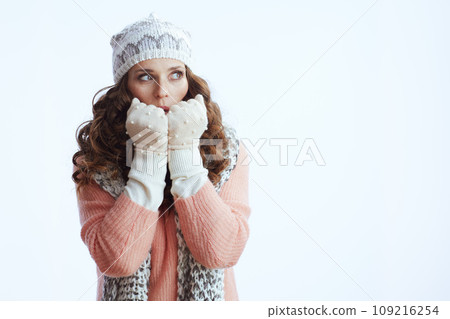 woman on looking on copy space and warming hands with breath 109216254