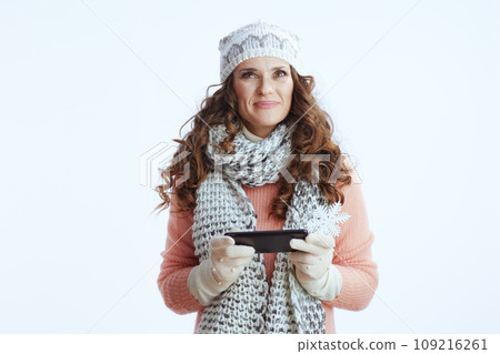 pensive trendy woman on sending text message using smartphone pensive trendy woman on sending text message using smartphone 109216261