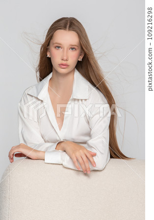 Portrait of a beautiful blonde girl with long blond hair and clear skin. Girl in a white shirt. Portrait of a beautiful blonde girl with long blond hair and clear skin. Girl in a white shirt. 109216298