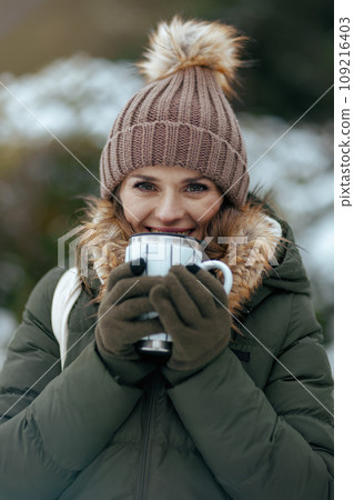 smiling 40 years old woman outdoors in park in winter smiling 40 years old woman outdoors in park in winter 109216403
