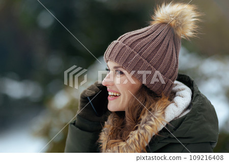 happy modern female outdoors in city park in winter 109216408