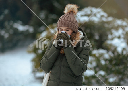 unhappy modern woman outdoors in city park in winter 109216409