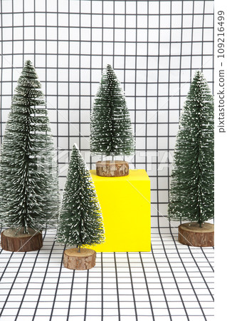 several fir and yellow cube on squared background 109216499