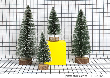 several fir and yellow cube on squared background 109216500