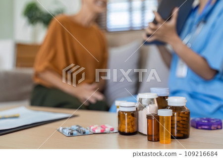 medicine on table and patient and doctor were talking in background 109216684
