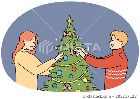 Happy couple decorate Christmas tree 109217128