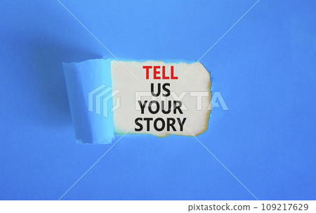 Tell us your story symbol. Concept word Tell us your story on beautiful white paper. Beautiful blue paper background. Business tell us your story concept. Copy space. 109217629